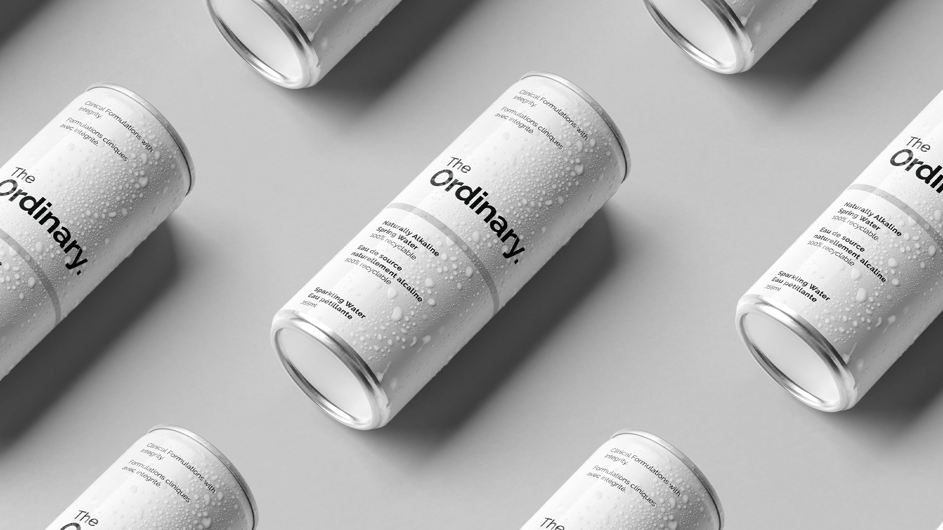Minimalist branded aluminum water can in a Deciem flagship retail environment